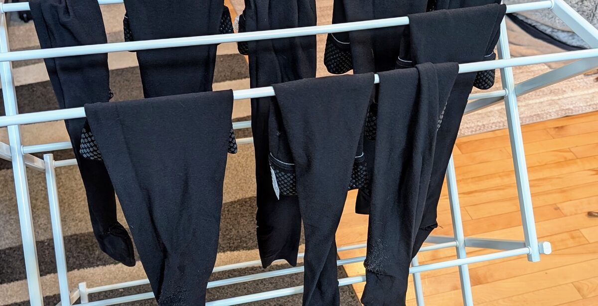 Multiple pairs of JOBST compression stockings air drying on a foldable rack